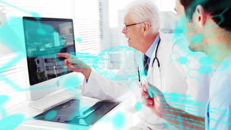 Senior doctor pointing at desktop monitor while mentoring junior doctor, showing AI brain graphics