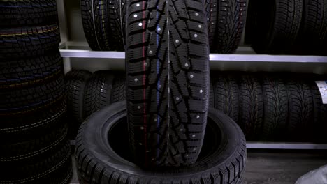 winter tire on the background of racks with tires.