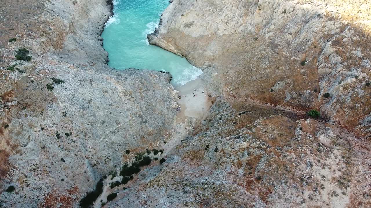 Majestic beach of mountains of Seitan Limania in Crete, aerial orbit view