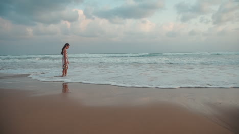 carefree girl meditating at seaside. happy teenager staying at coastline.