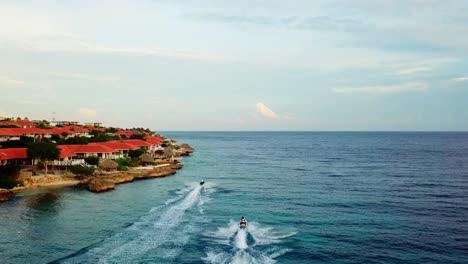 Aerial-view-dolly-in-of-two-jet-skis-on-the-shores-of-Jan-Thiel-Beach,-Curacao,-Dutch-Caribbean-island