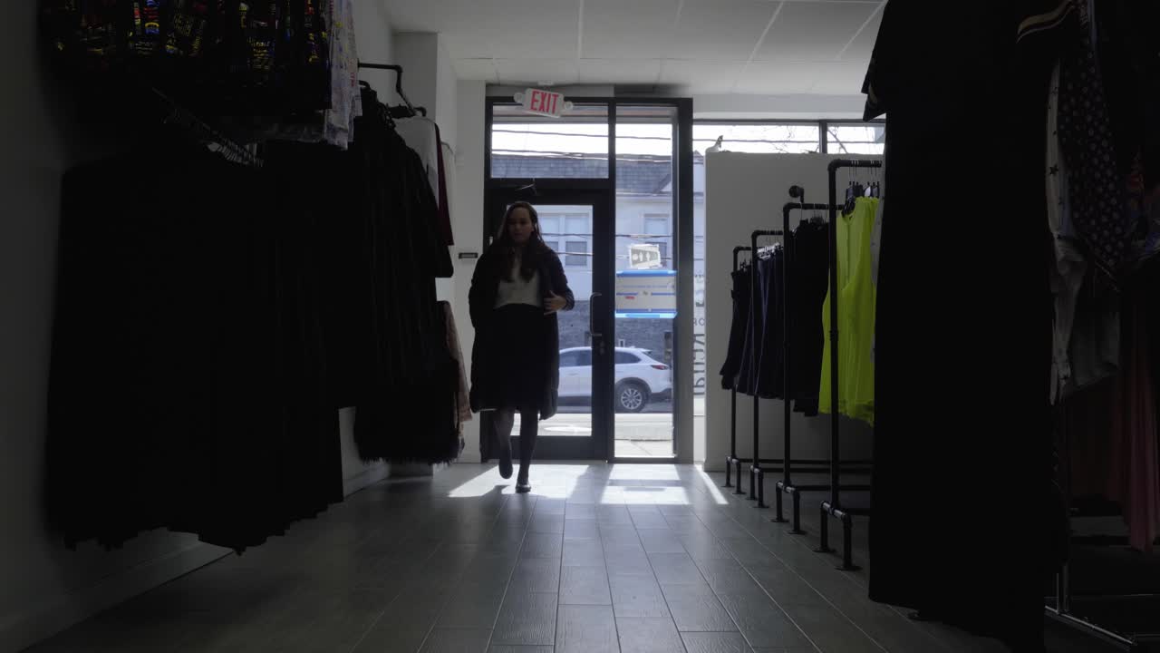 Woman enters retail store and turns on the light