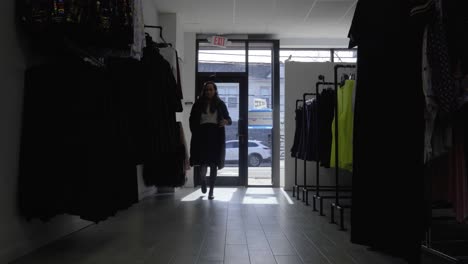 woman enters retail store and turns on the light