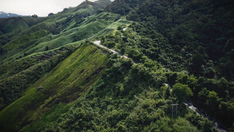 Aerial-view-flying-above-lush-green-tropical-rain-forest-mountain-with-rain-cloud-cover-during-the-rainy-season-on-the-Doi-Phuka-Mountain-reserved-national-park-the-northern-Thailand