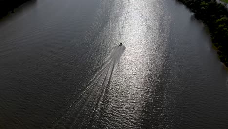 drone following boat cruising in the water