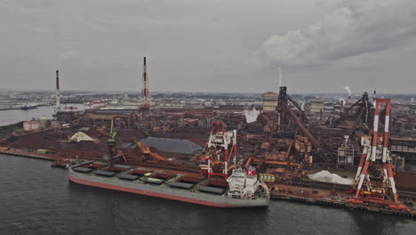 nagoya japan aerial v3 drone flyover port capturing massive industrial site of steel furnace plant in operation situated in tokaimachi under an overcast sky - shot with mavic 3 pro cine - october 2023