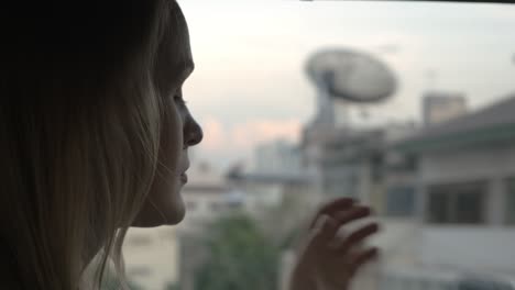 woman traveling by bus in the city and using cellphone