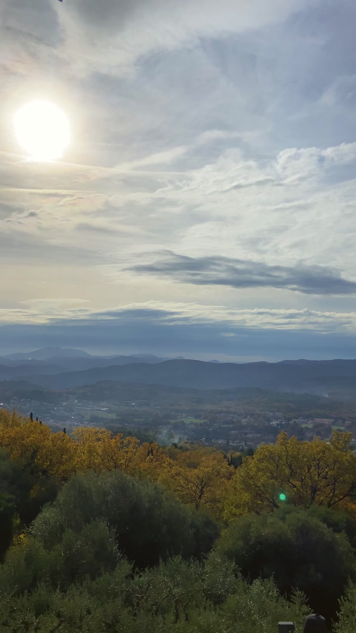 UGC style vertical phone reel of panorama of the Provence region in France. Overcast day in beautiful valley surrounded by hills and mountains during autumn in European village or town. POV mobile