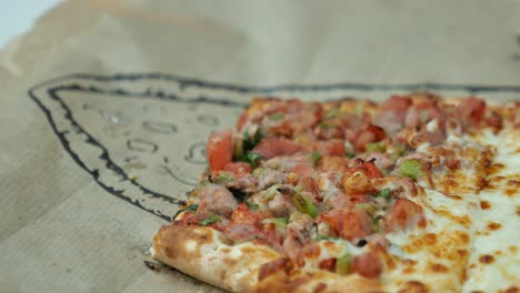 person eating a slice of turkish pizza