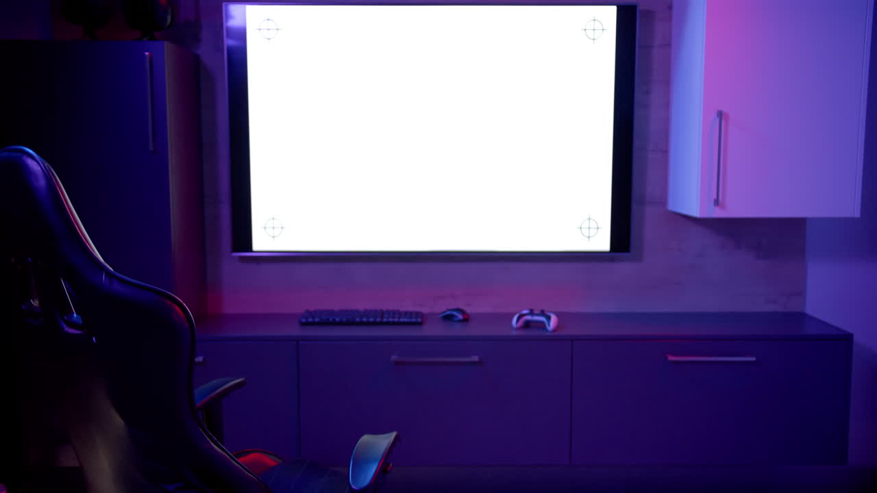 In home office, large monitor, gaming chair, keyboard, and controller setup, copy space