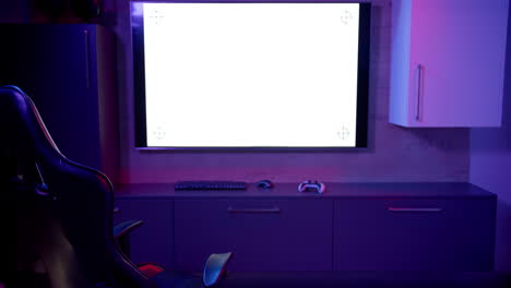 in home office, large monitor, gaming chair, keyboard, and controller setup, copy space