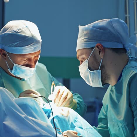 blepharoplasty in clinic. professional doctors doing a plastic surgery on a patient's face. male specialists doing skin correction on eyelid.