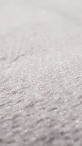 white fabric with glitter threads at bright light extreme close view. textile material texture sheet. shiny flat cotton cloth textured surface