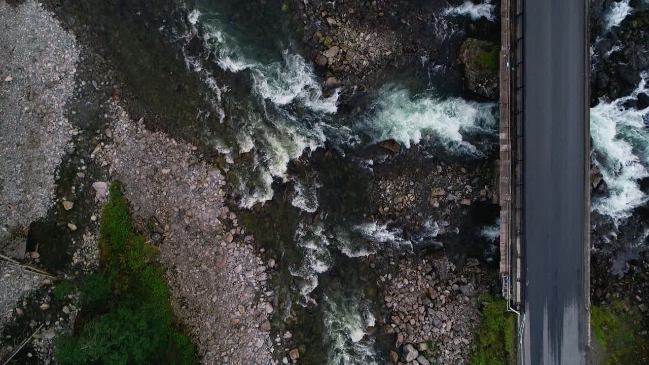 Aerial Bird's Eye of Car Passing over Låtefoss Bridge at Låtefossen Waterfall