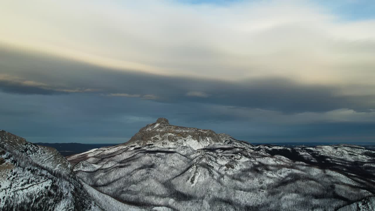 Drone gimbal down revealing a great and incredible snow-capped mountainside of Rocky Canadians