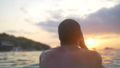 swimmer emerging from the sea at sunset