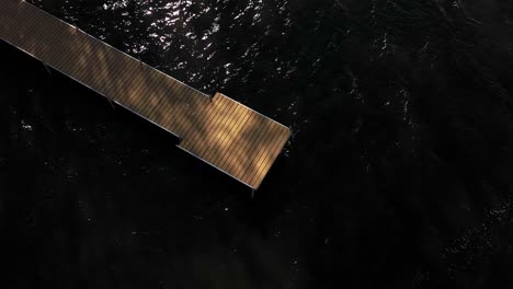 dock on top of dark water aerial