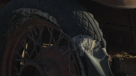 close up view of old ripped abandoned car tyre. locked off