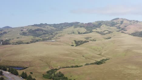 Wide-aerial-dolly-shot-of-Hearst-Castle-perched-high-up-in-the-hills-above-San-Simeon,-California