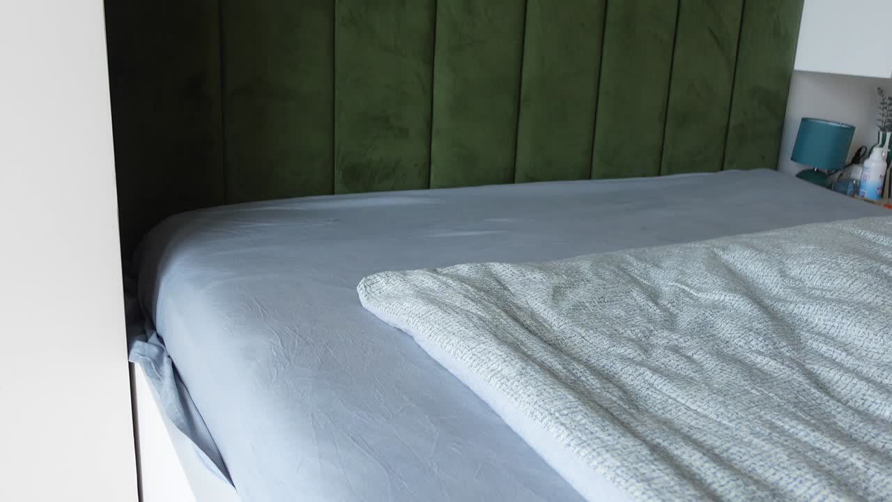 Bedroom Interior with Green Wall and Gray Bedding
