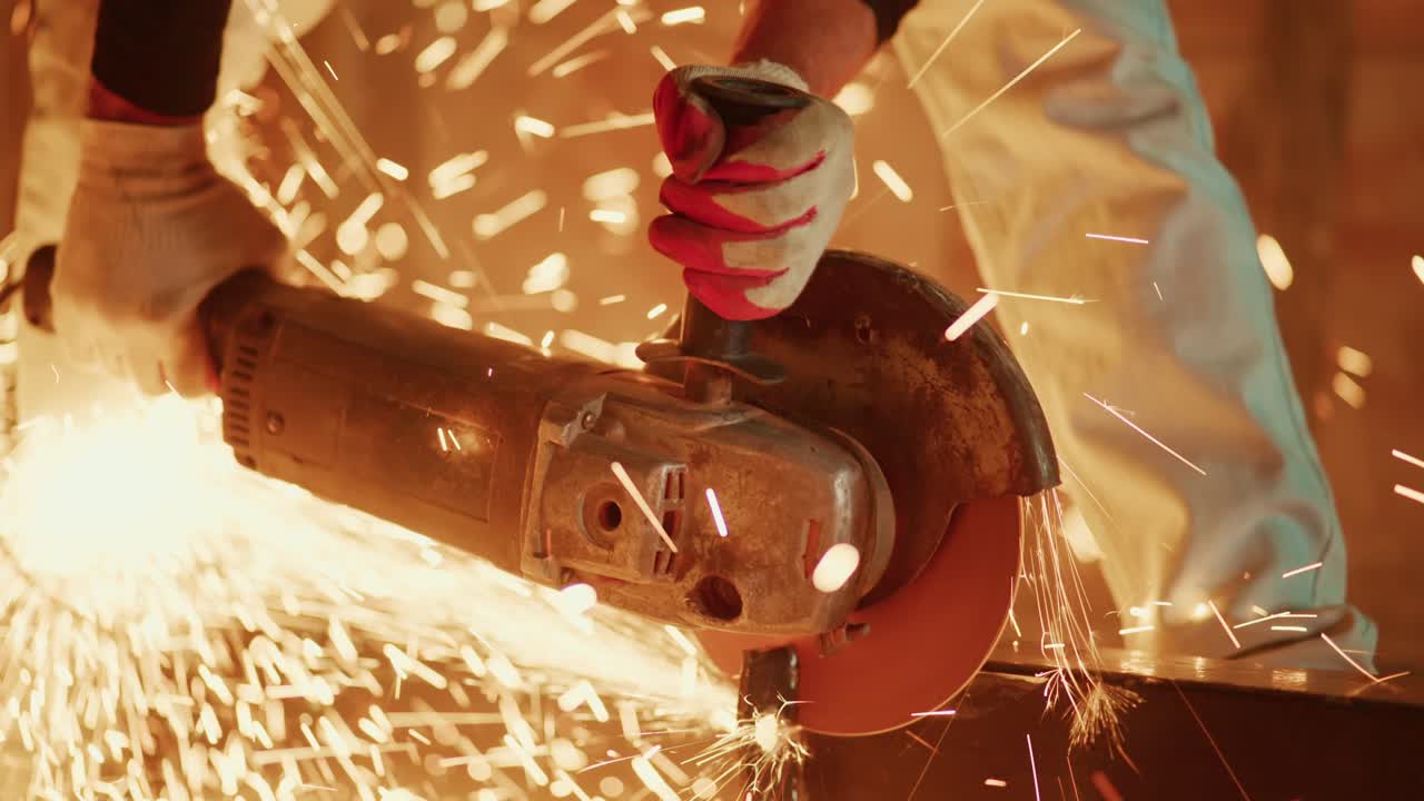Close-up of Worker Grinding Metal with Angle Grinder and Bright Sparks