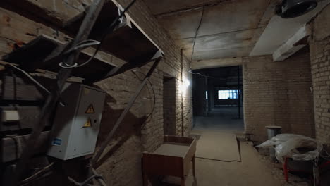 brick wall corridor in the newly-built premise. a walk by the interior of the unfinished building.