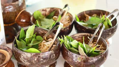 coconut shells filled with herbs and condiments