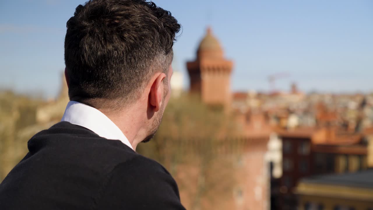 Businessman looking out over a city during his workday for some fresh air
