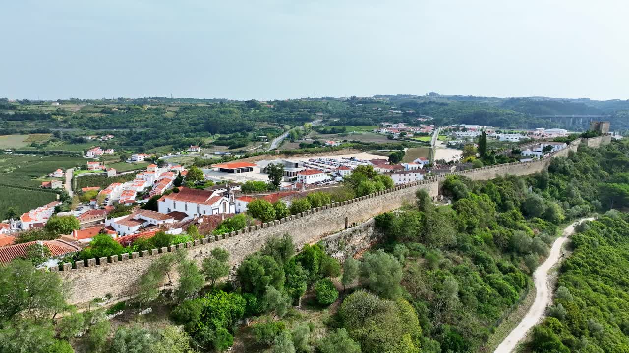 Drone footage of the long medieval wall at Obidos castle in Portugal.