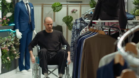 man in wheelchair shopping for men's clothing in a store