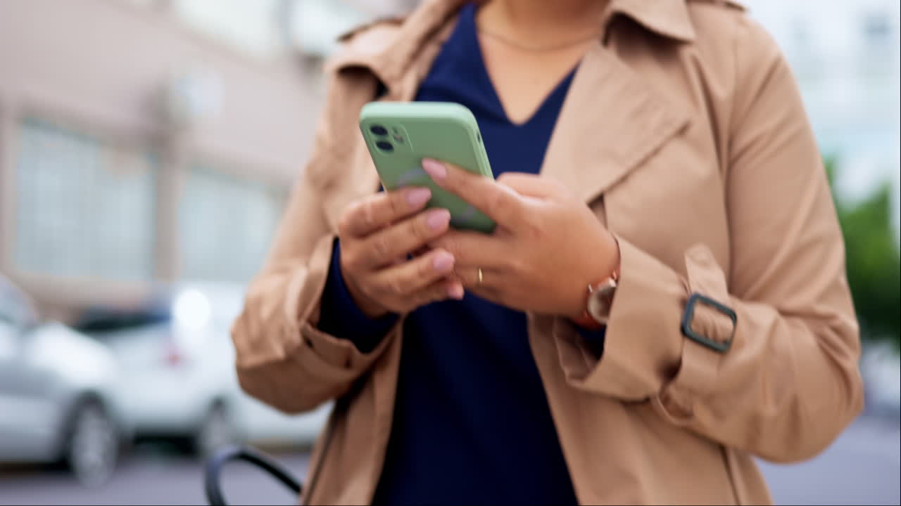 Phone, hands typing and walking in city