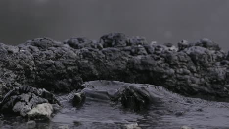 Boiling-hot-geothermal-volcanic-mud-pool,-closeup-shot-steamy-lake-bubbling-mud-and-steam-satisfying