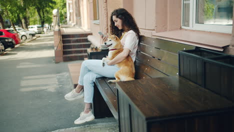 woman with dog on a park bench