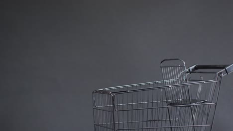 Video-of-shopping-trolley-with-copy-space-over-grey-background