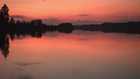 time lapse of a beautiful sunset in norway with a reflective lake in the front