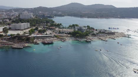 ksamil coastline on albanian riviera with beach clubs and water toys, meditteranean ocean