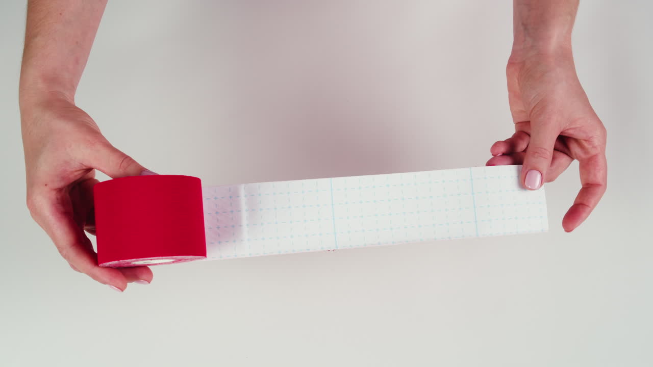 Kinesiology medical taping, doctor Physical therapist applying elastic surgical tape to patient body, treating injured knee young athlete.Post traumatic rehabilitation, sport physical therapy recovery