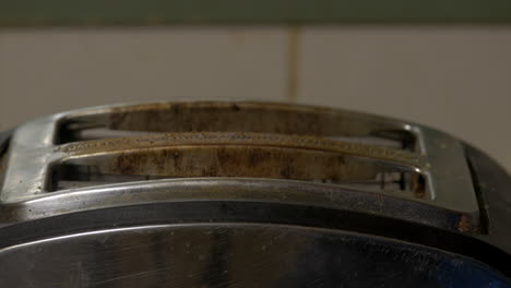 bread in a toaster being pushed down to cook