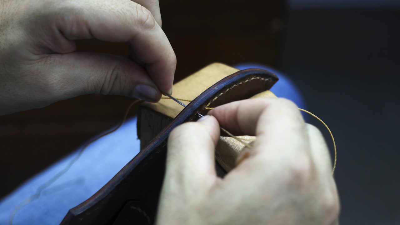 Sewing leather with a Stitching pony support made to hold the  piece in place viewed from POV