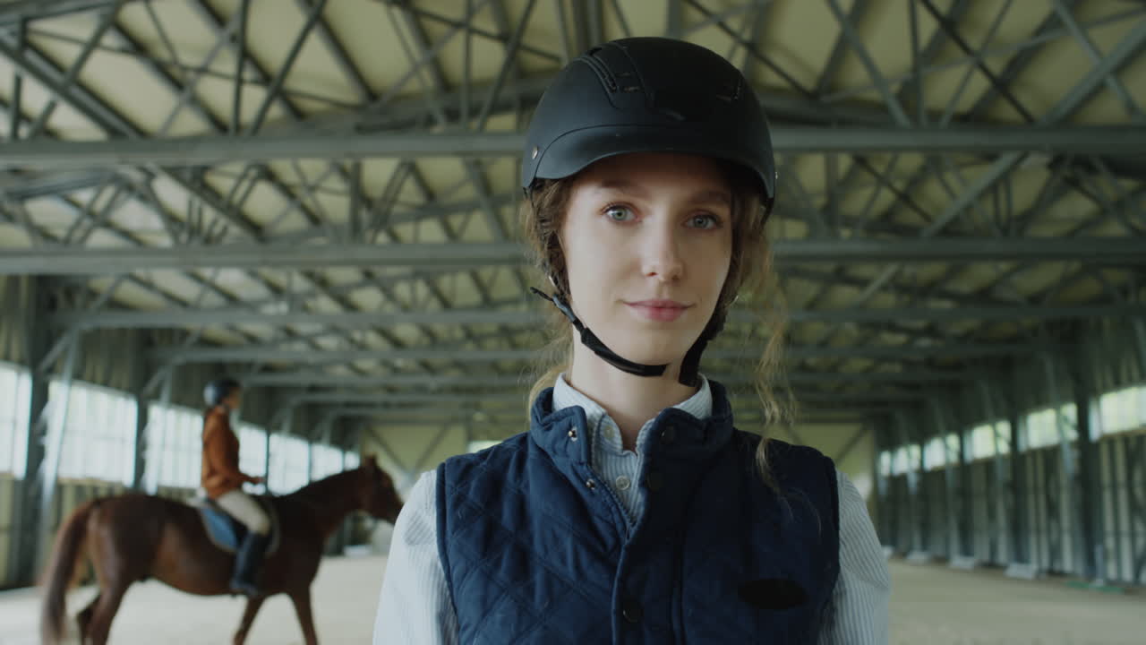 Portrait of a Young Equestrian Woman in an Indoor Riding Arena