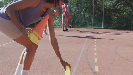 Happy-diverse-female-basketball-team-training-on-sunny-court,-copy-space,-slow-motion