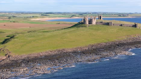 dunstanburgh castle ruins on the northumberland coast, england
