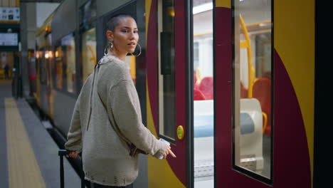 woman getting off a train at a station