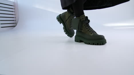 woman walking in trendy green boots
