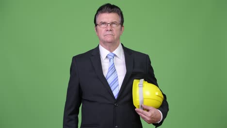 senior handsome businessman as engineer giving handshake