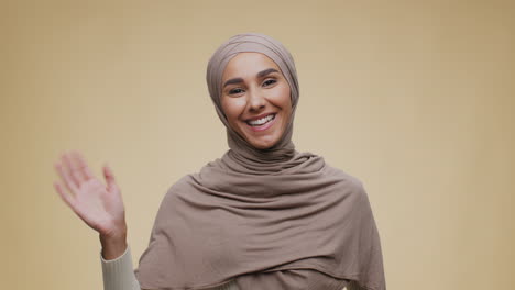 woman in hijab smiling and greeting