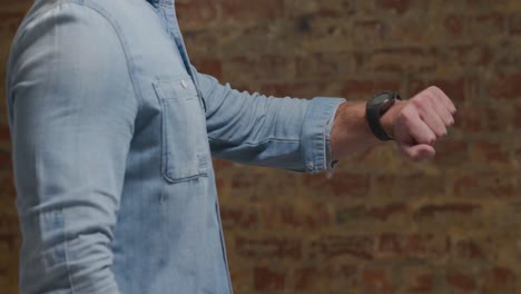 man checking smartwatch