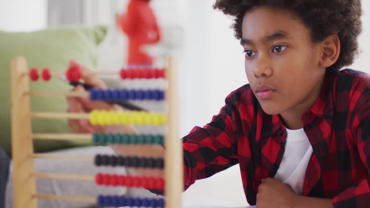 Boy using abacus at home