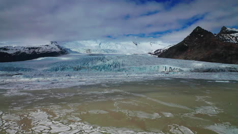drone flying over the majestic fjallsarlon glacial lake in south iceland - drone shot
