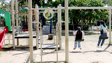 children swinging joyfully in rama 9 park